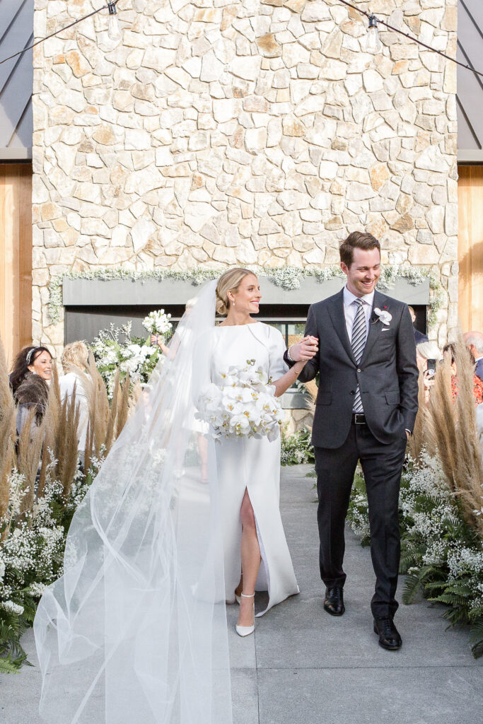 Bride and groom walking back up the aisle after their ceremony at Estate Yountville, Napa Valley wedding venue