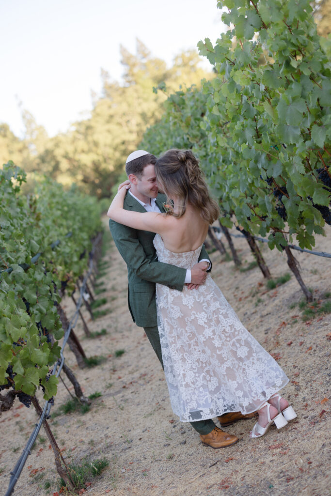 Jewish wedding ceremony at Estate Yountville framed by grapevines and late afternoon light