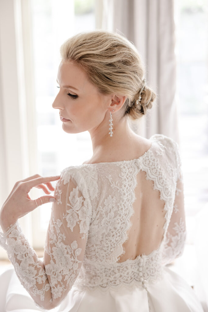 Bride wearing a lace wedding gown during portrait time at Carneros Resort and Spa, photographed outdoors in Napa Valley at a Wine Country wedding venue.
