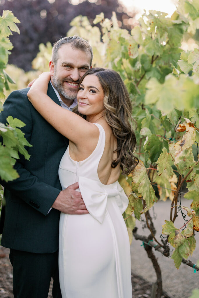 Bride and groom smiling together in the vineyards at Carneros Resort and Spa, Napa Valley wedding photography