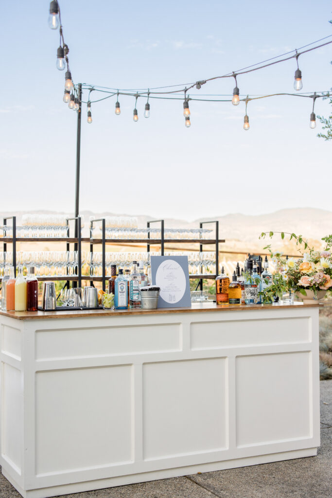 Luxury outdoor wedding bar setup at Carneros Resort and Spa with Napa Valley views at sunset