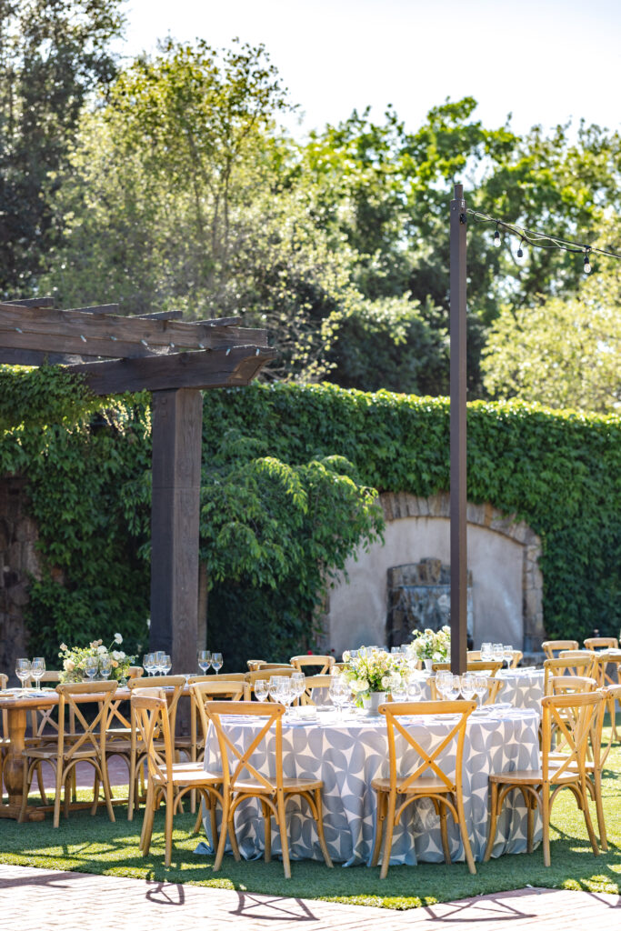 Outdoor reception table setup at the Pavilion at Estate Yountville with garden surroundings