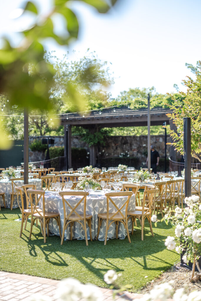Garden reception tables at the Pavilion at Estate Yountville surrounded by greenery and string lights