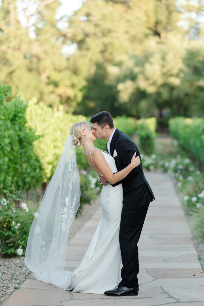 Bride and groom sharing a quiet moment along the garden paths and vineyard at Estate Yountville during golden hour
