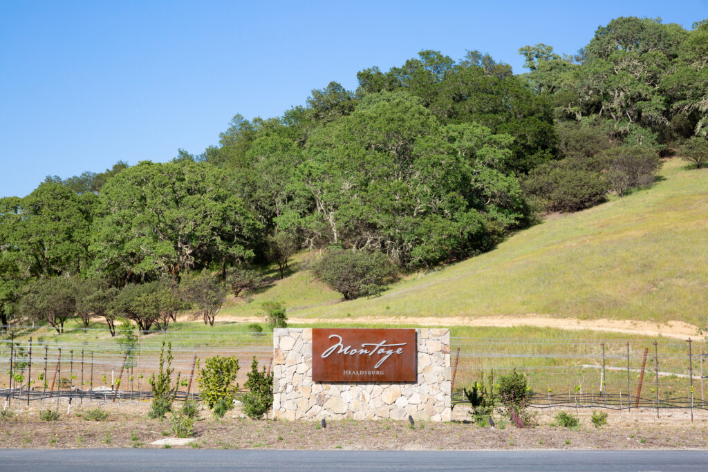 Montage Healdsburg entrance sign surrounded by rolling hills and vineyards in Sonoma wine country