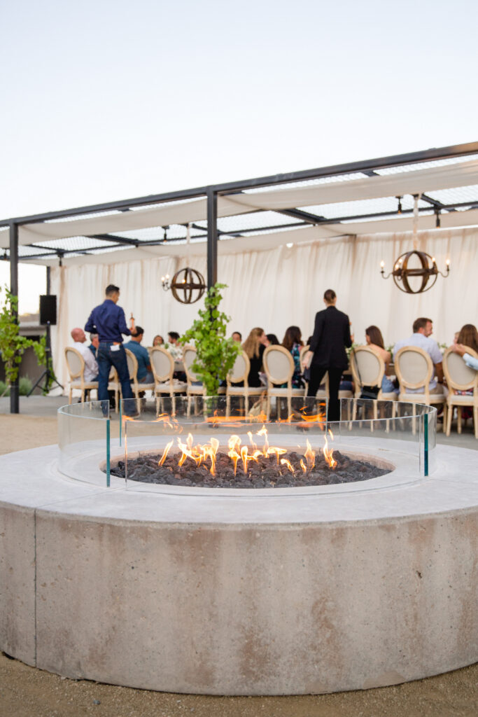 Guests gathered around fire pit lounge area at Montage Healdsburg wedding reception