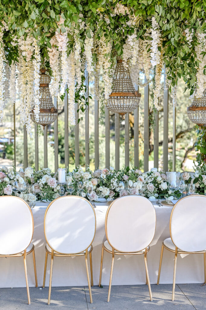Floral installation and hanging greenery above reception table at Montage Healdsburg wedding venue