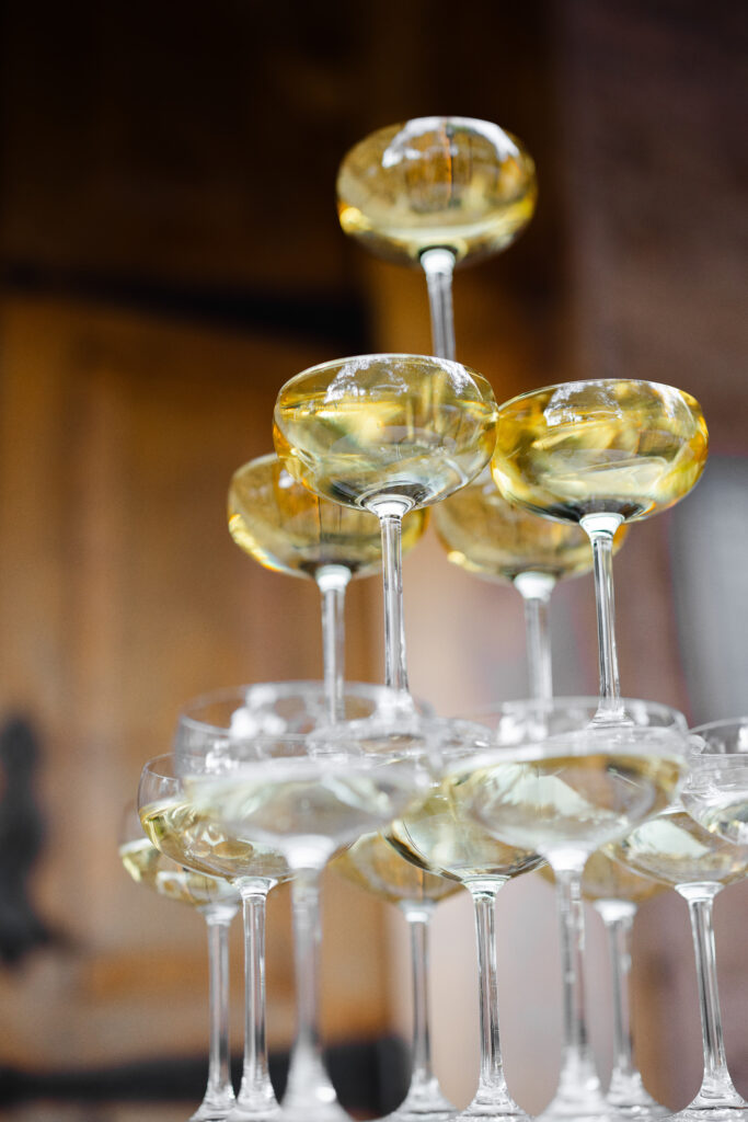 A close up detail of a champagne coupe tower at a Napa Valley wedding reception, photographed by Suzanne Karp Photography
