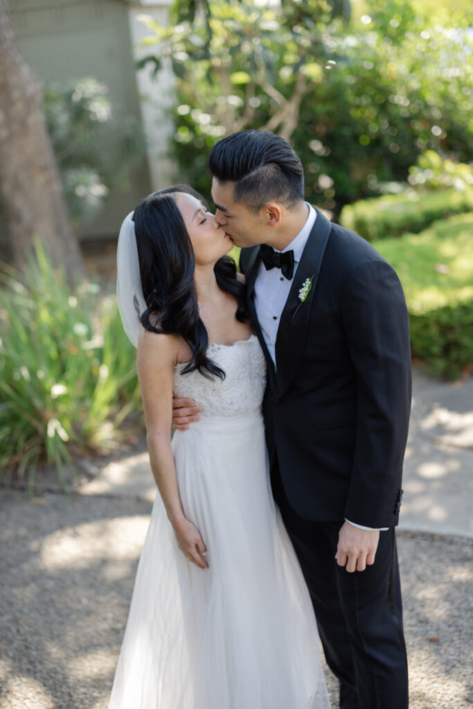 A groom kisses his bride on the cheek during their Napa Valley wedding portrait session, photographed by Napa wedding photographer Suzanne Karp
