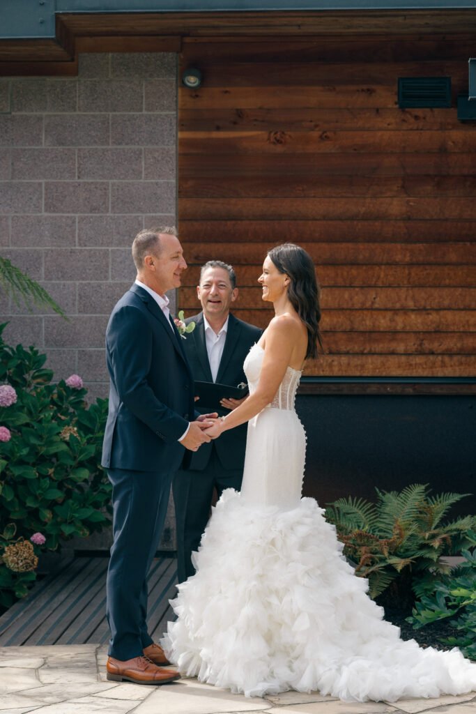 Graham of Ceremonies by Graham officiates as a couple holds hands during their elopement ceremony at Bardessono in Yountville